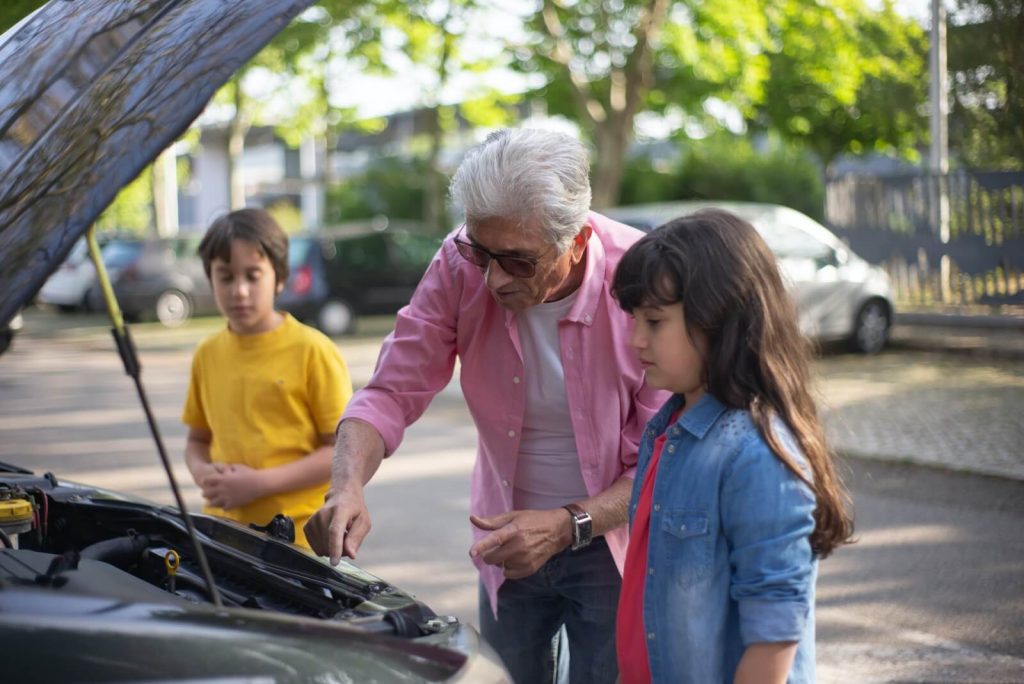 grandfather shows children auto repairs in Columbus