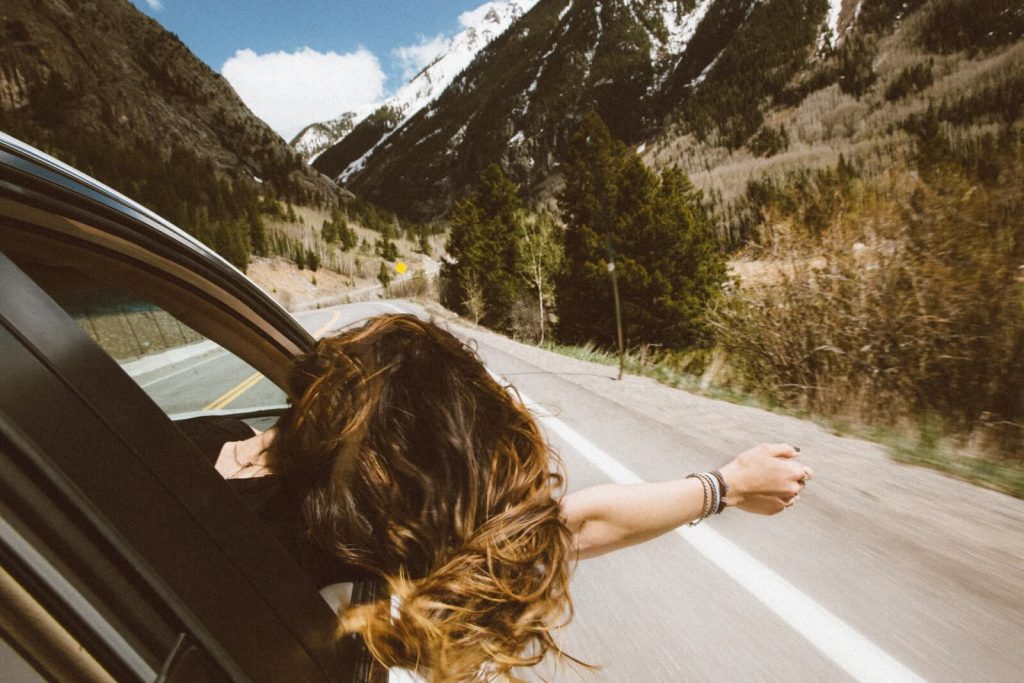 Columbus woman hangs head and arm out of insured automobile's passenger window