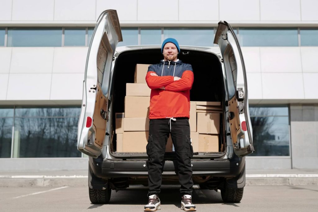Columbus delivery driver stands in front of package-filled van